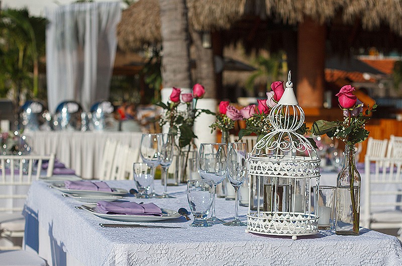 Wedding reception with rectangle tables with decorative roses.