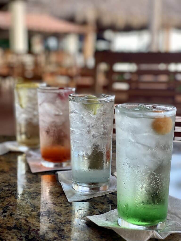 Refreshing cocktails lined up on a bar counter.