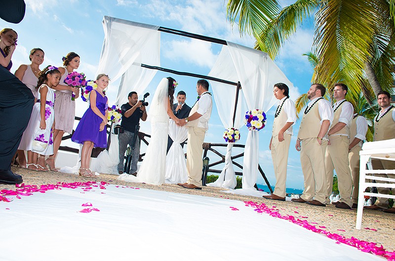 ground view of a wedding ceremony with the ocean behind the ceremony.