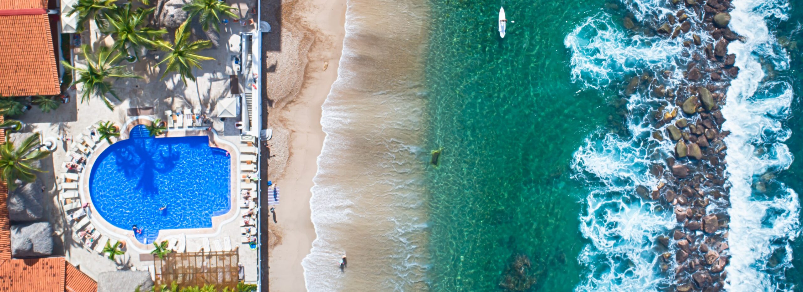 Aerial view of hotel pool and adjacent beach.