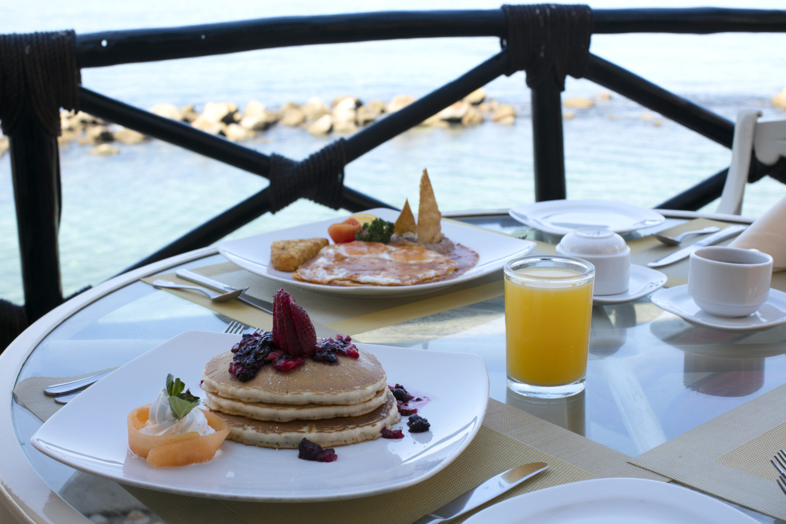 Breakfast with ocean view on a terrace.