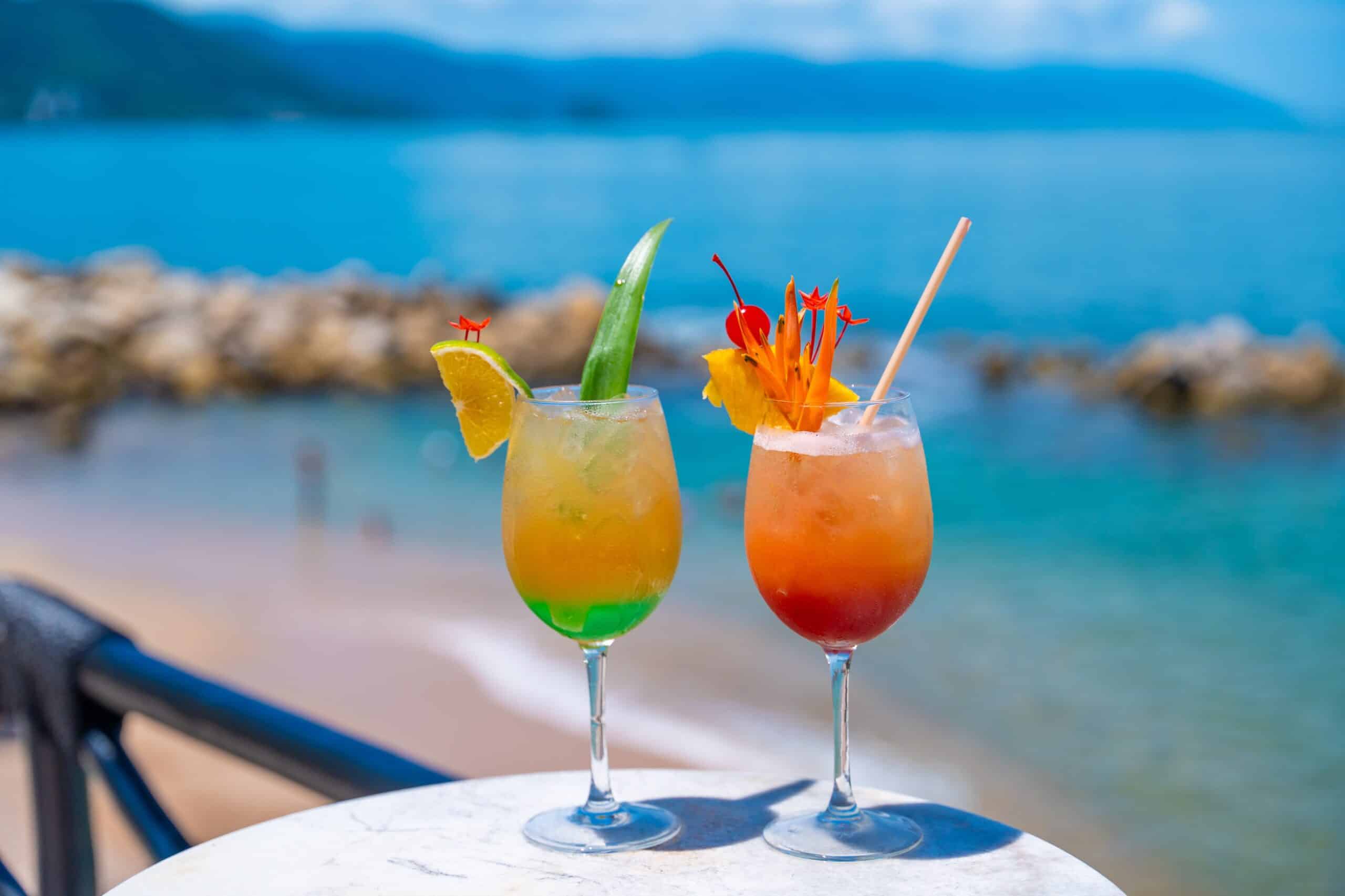 A vibrant cocktail image featuring various colorful drinks in elegant glasses against a neutral background.